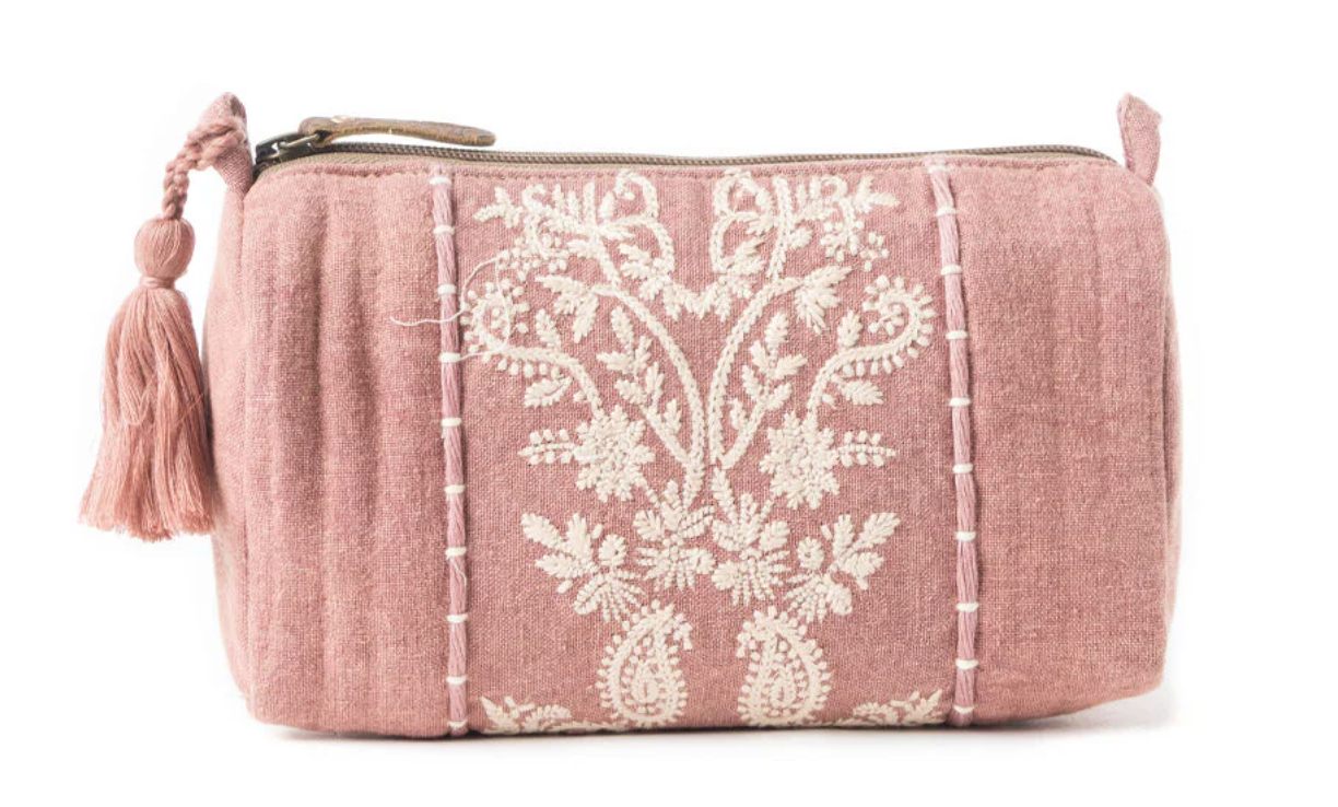 Blush pink embroidered clutch with ivory floral lace detailing and a tassel zipper pull in soft fabric.