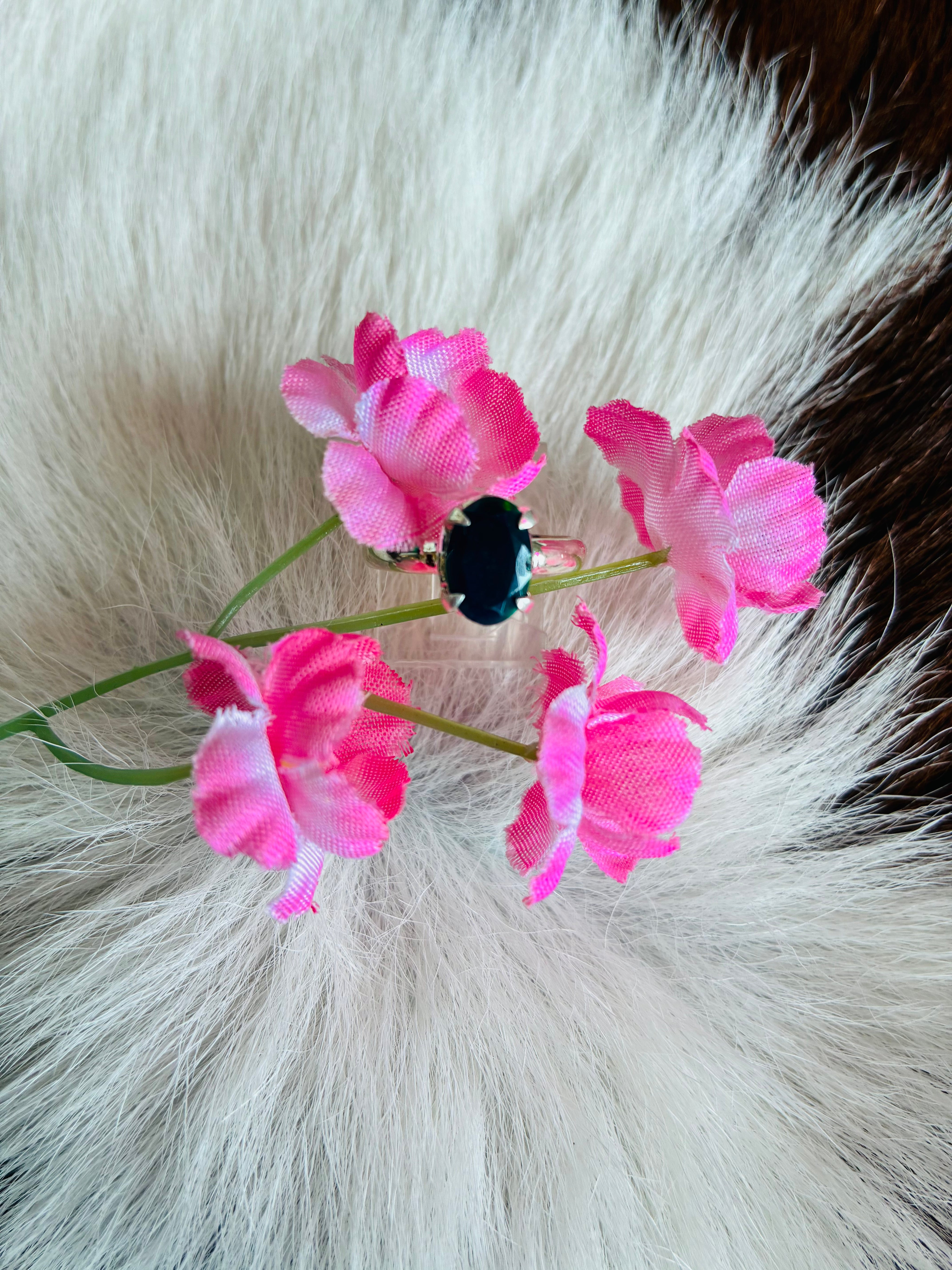 Black ring with flower and cowhide rug 