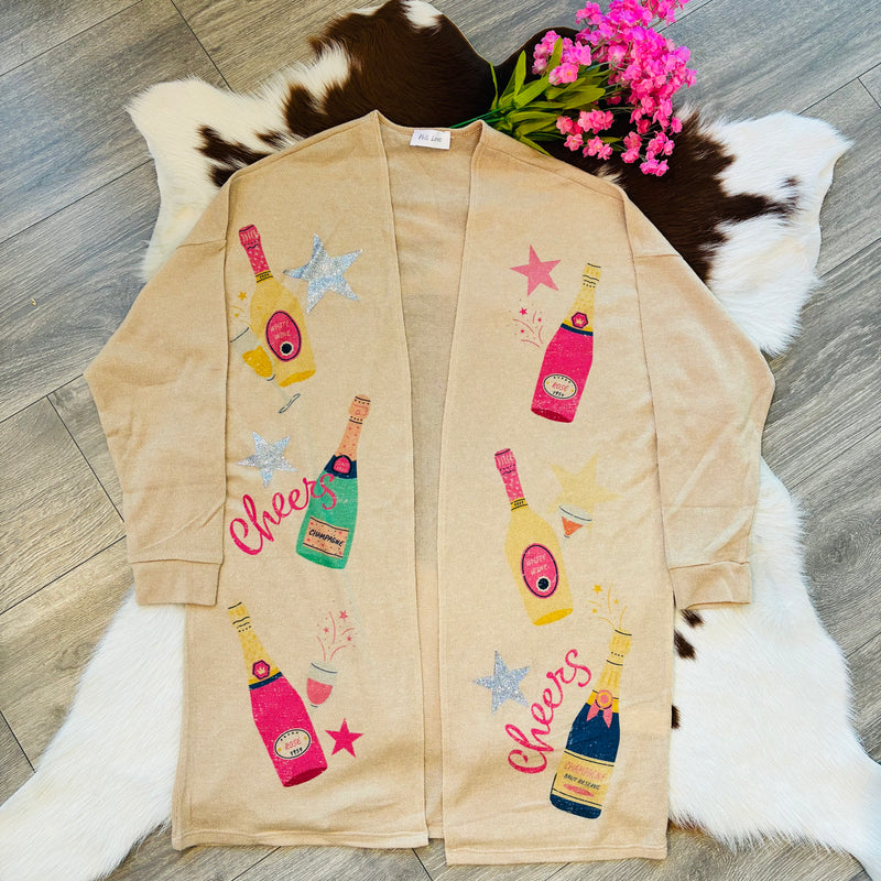 Beige robe with colorful bottle and star designs on a wooden floor.