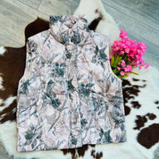 Floral patterned vest on a cowhide rug with pink flowers