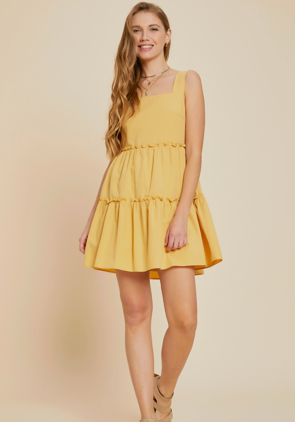 Yellow tiered mini dress with a square neckline, ruffle skirt, and a relaxed fit, made from 100% cotton for a breathable and lightweight feel, perfect for spring and summer fashion.