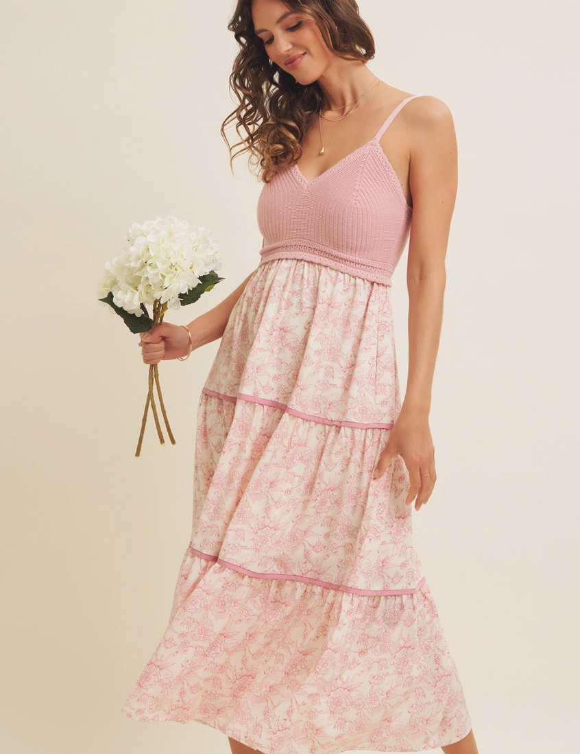 Pink floral maxi dress with a knit crochet bodice, tiered flowy skirt, and adjustable spaghetti straps, perfect for spring and summer occasions.