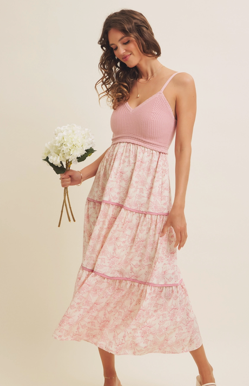 Pink floral maxi dress with a knit crochet bodice, tiered flowy skirt, and adjustable spaghetti straps, perfect for spring and summer occasions.