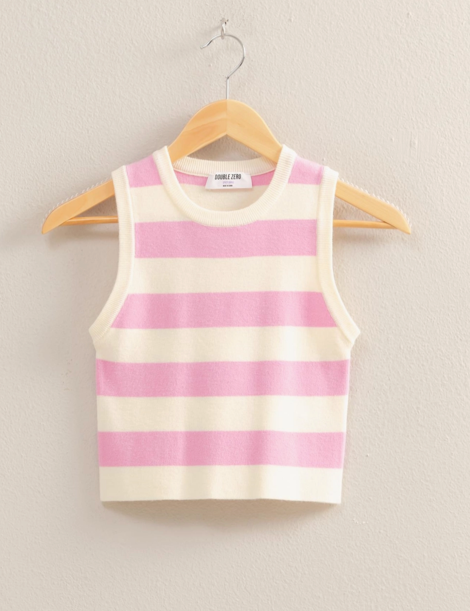 Pastel pink and cream striped sleeveless knit tank top with a cropped fit, ribbed crew neckline, and soft stretchy fabric blend of 50% Rayon, 28% Polyester, and 22% Nylon, perfect for spring and summer fashion.