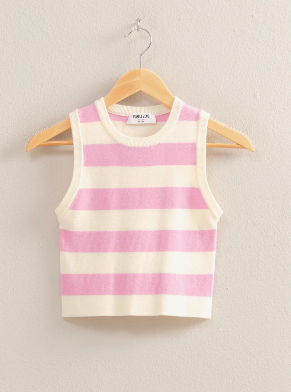 Pastel pink and cream striped sleeveless knit tank top with a cropped fit, ribbed crew neckline, and soft stretchy fabric blend of 50% Rayon, 28% Polyester, and 22% Nylon, perfect for spring and summer fashion.