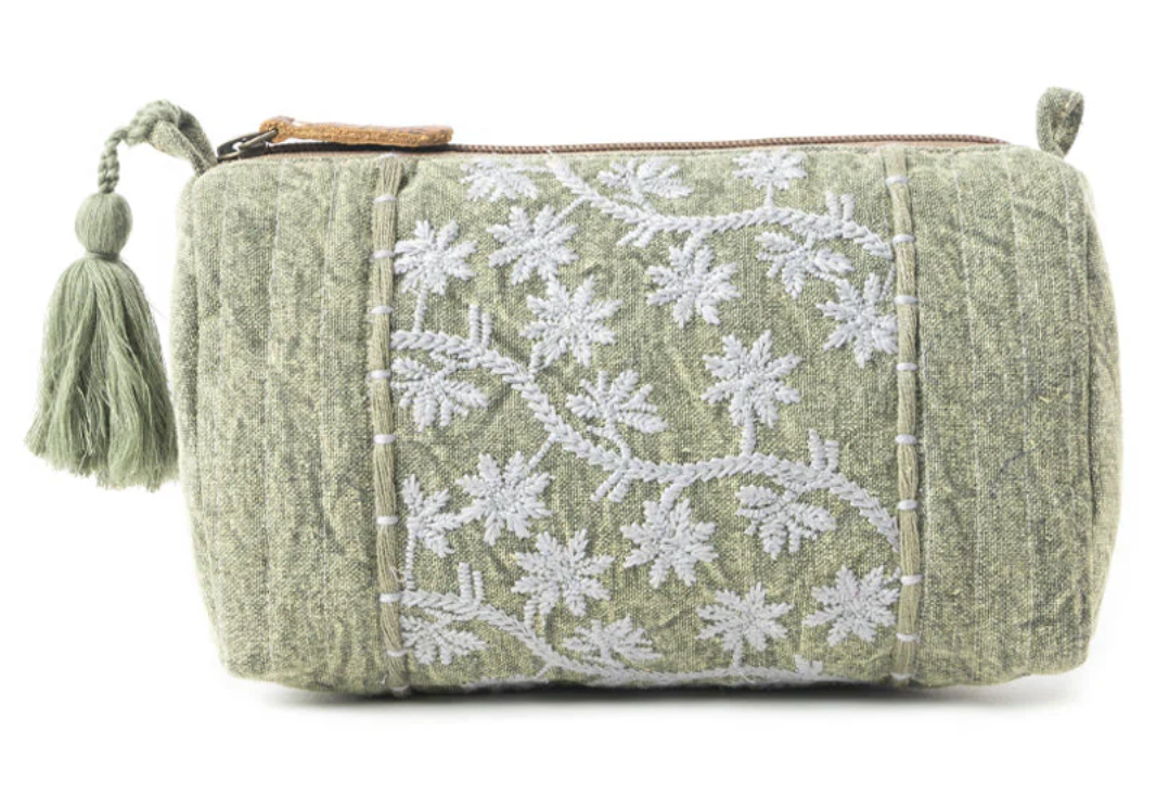 Sage green boho clutch bag with white embroidered floral design and matching tassel zipper pull.