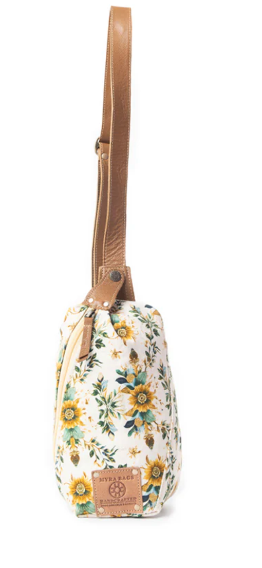 Floral fanny pack bag with yellow and green blossoms, cream canvas body, and tan faux leather adjustable strap.