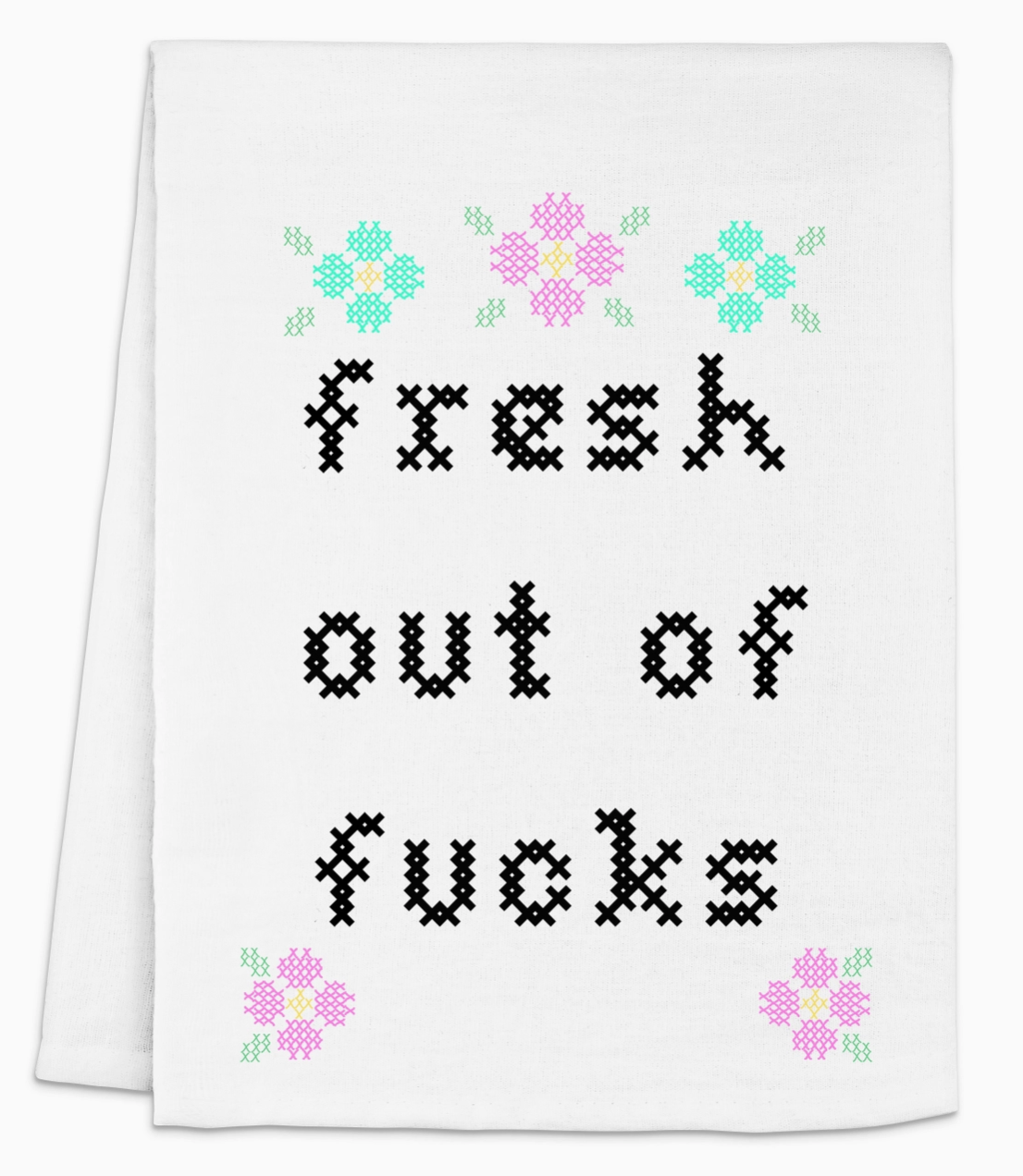 A white towel with the phrase "Fresh Out of F*cks" in black cross-stitch font, surrounded by colorful floral designs.