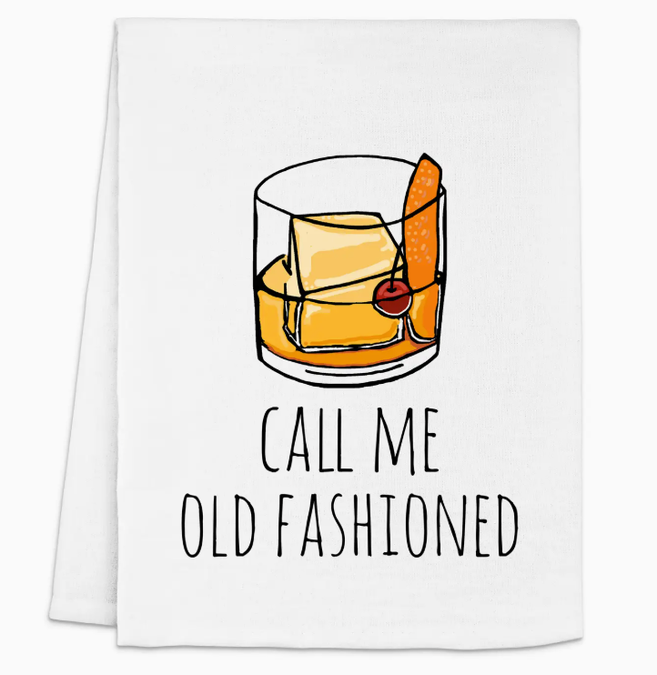 A white towel featuring the phrase "Call Me Old Fashioned" in black text, with an illustration of a cocktail glass containing whiskey, ice, and a cherry.Get yours today and let your towel add a touch of elegance and humor to your kitchen! 🥳✨