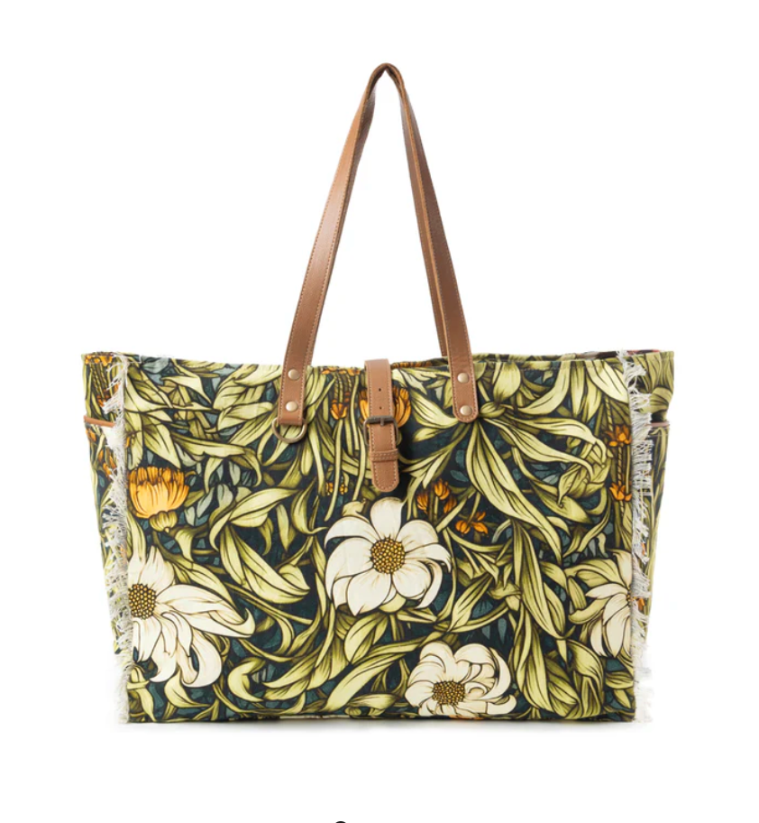 Floral patterned tote bag with brown handles on a white background