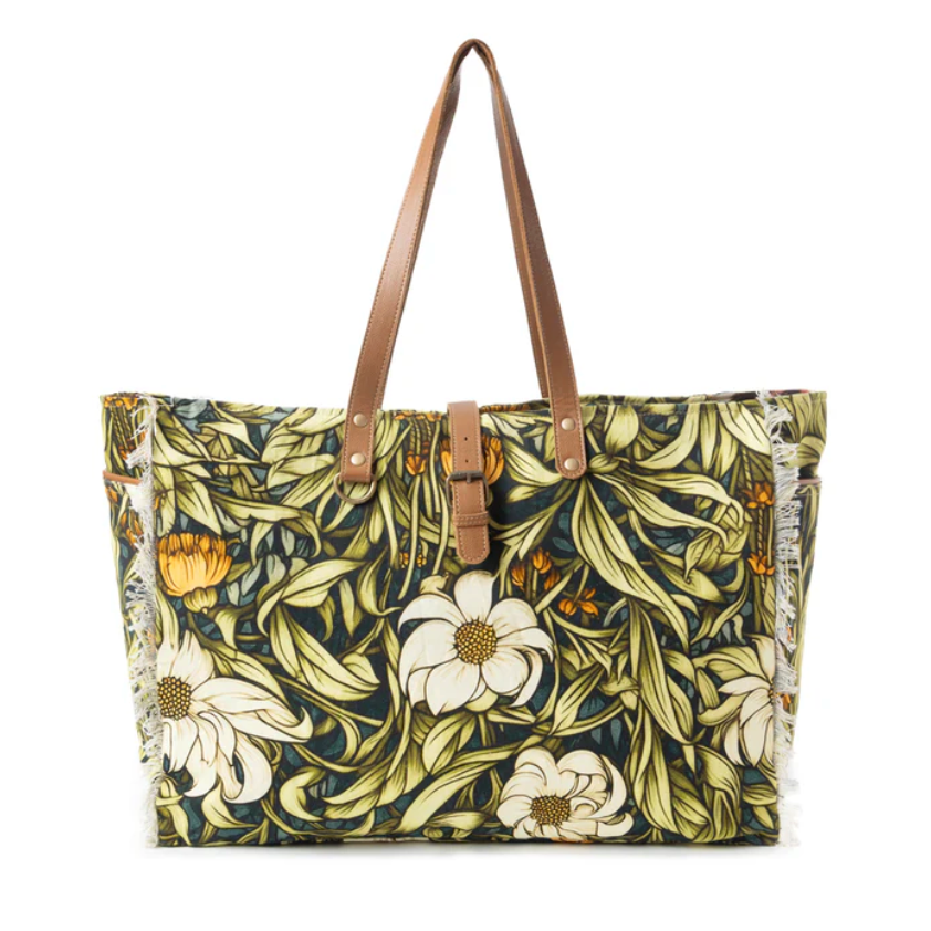 Floral patterned tote bag with brown handles on a white background