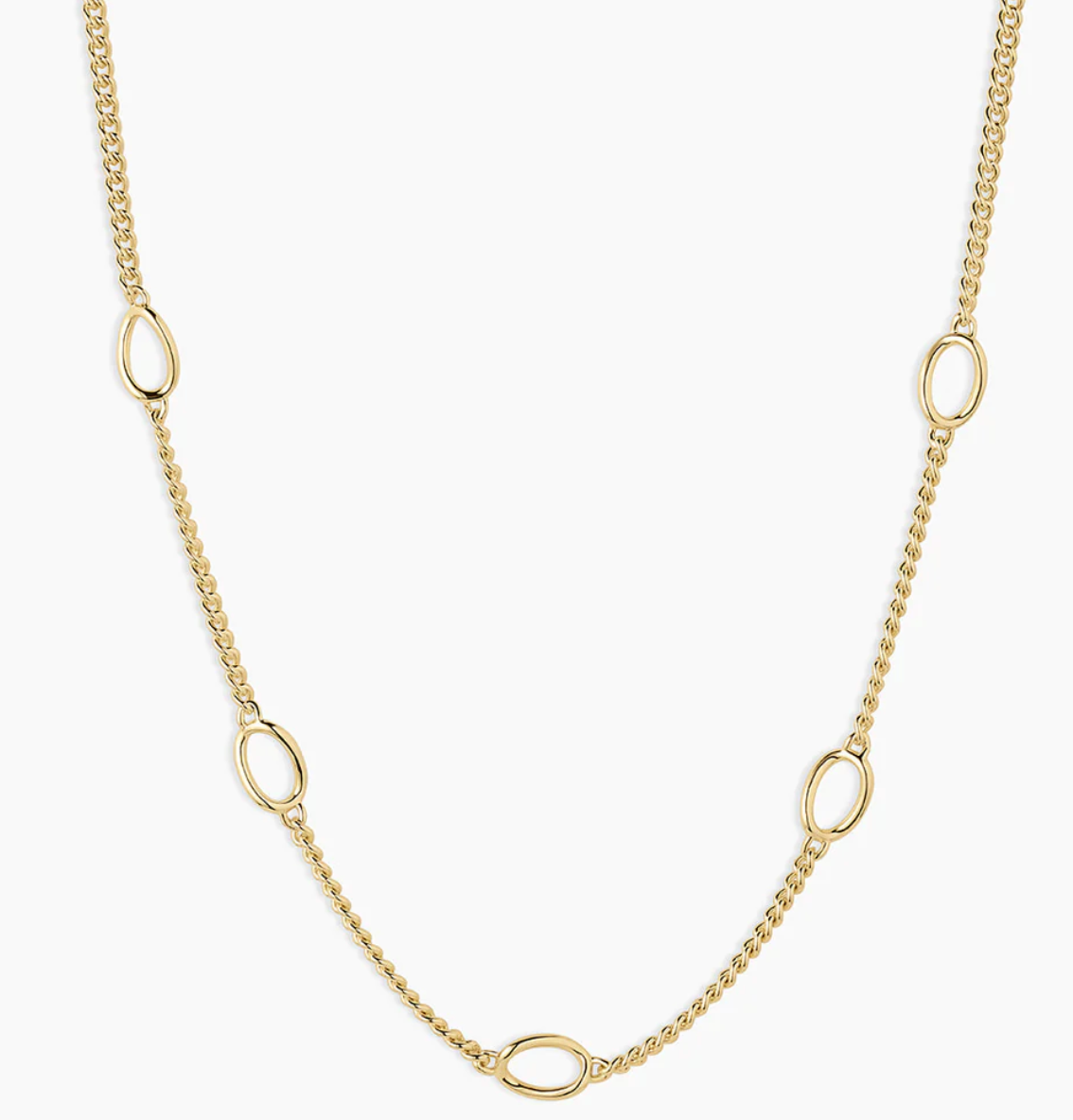 Close-up of a delicate gold necklace featuring a classic chain design interspersed with oval links. This elegant piece is perfect for layering or wearing alone, adding a subtle touch of sophistication to any outfit.Let me know if you need any further assistance or additional information!